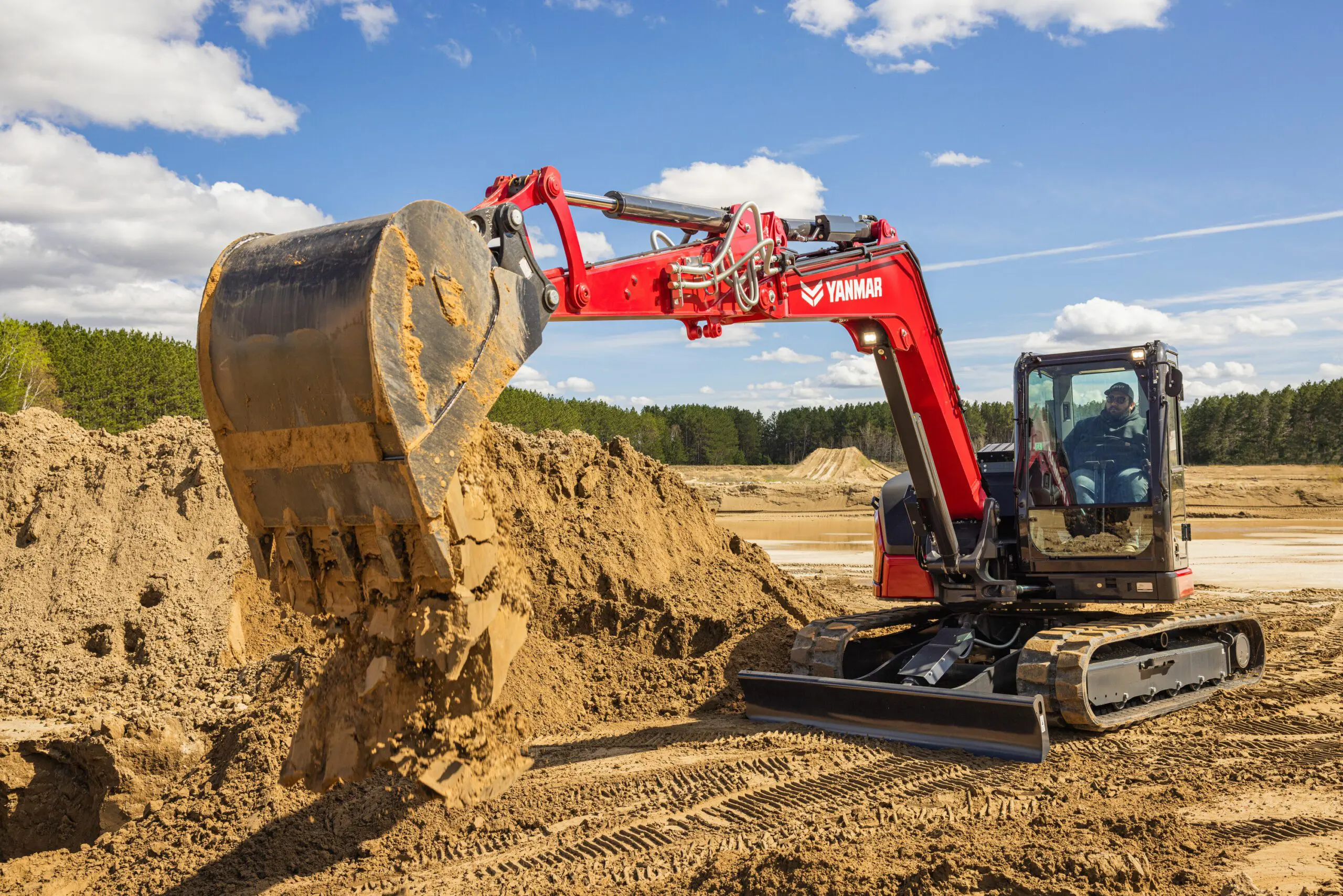 Mini Excavator ViO80-7 excavating with the bucket on the foreground.
